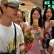 People taking photos of the squirrel monkey.